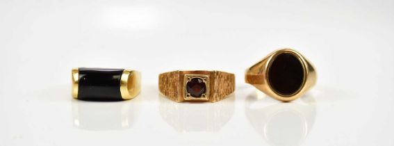 A 9ct yellow gold gentleman's dress ring, size O, together with two further 9ct yellow gold