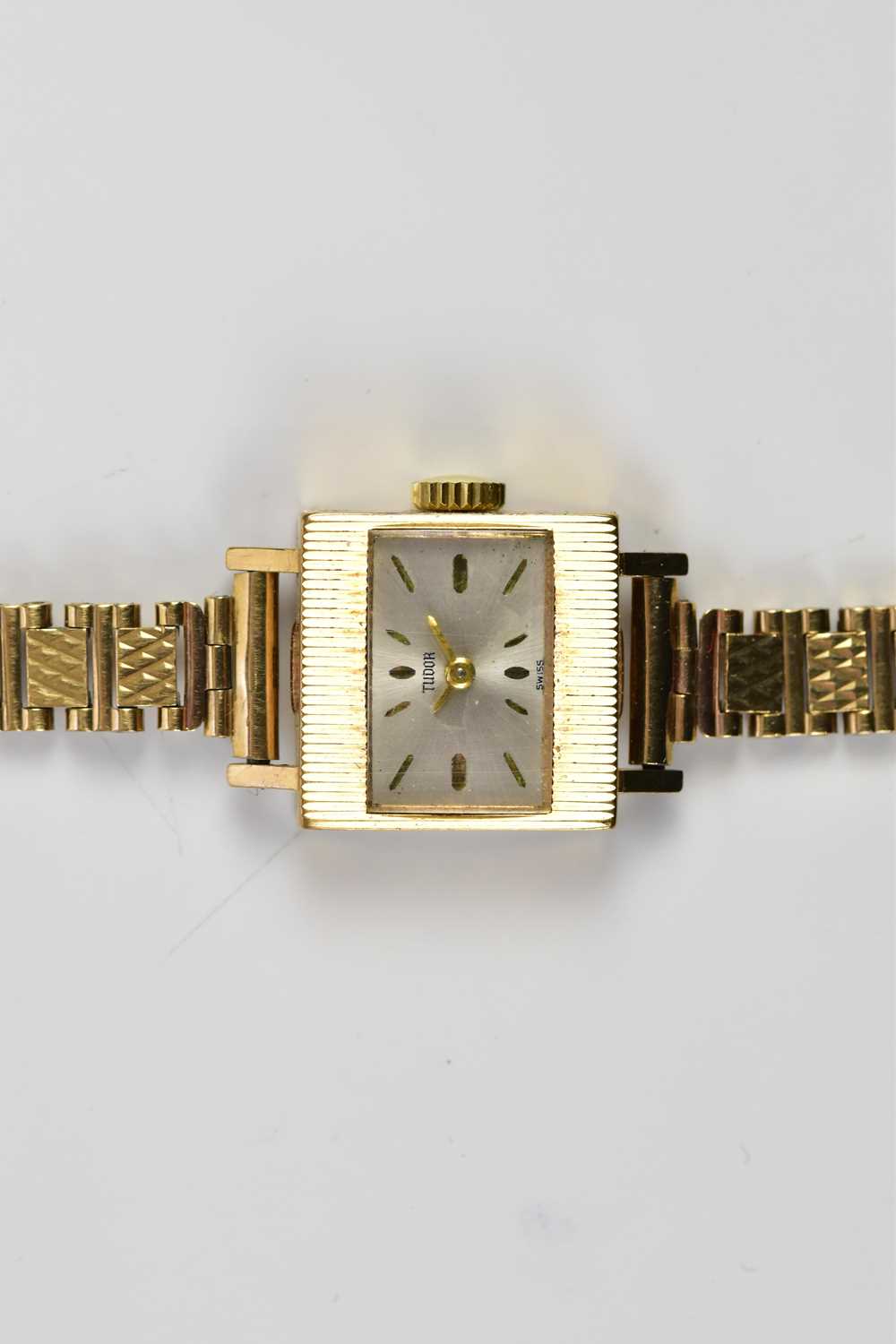 TUDOR; a lady's 9ct gold cased wristwatch, the dial set with batons, suspended on a 9ct gold
