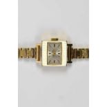 TUDOR; a lady's 9ct gold cased wristwatch, the dial set with batons, suspended on a 9ct gold