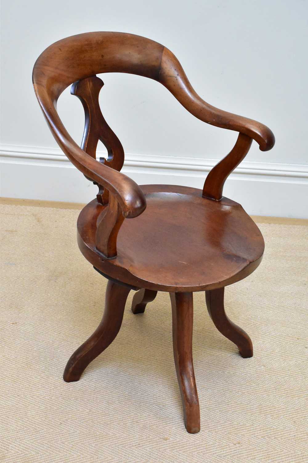 An early 20th century mahogany captain's chair.