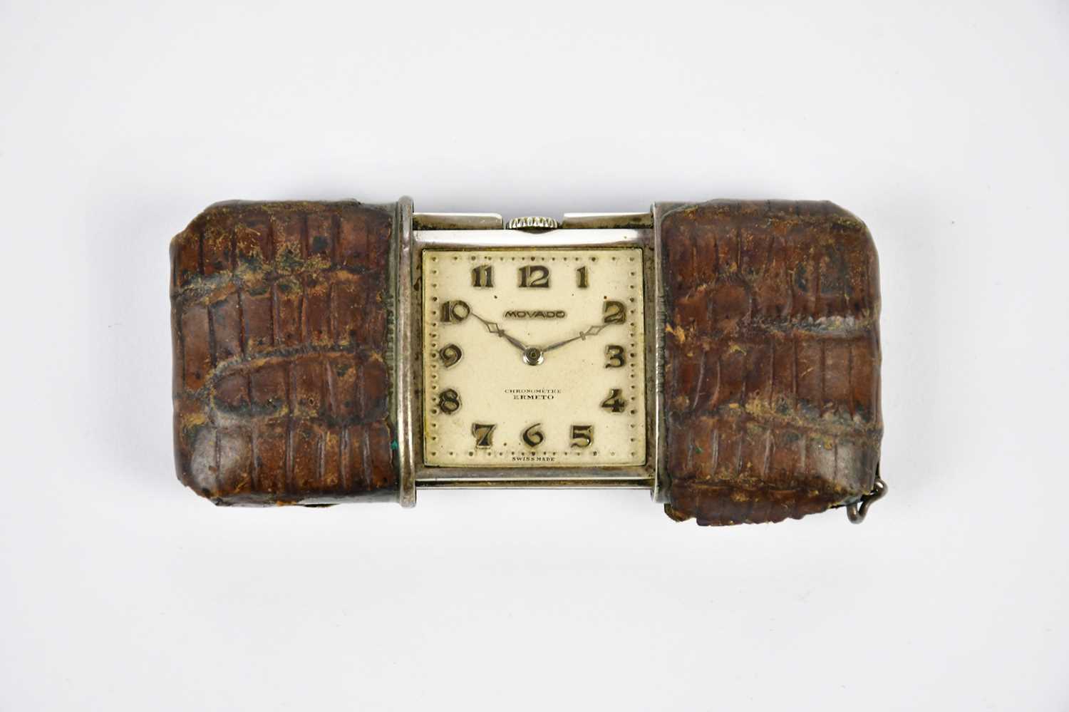 MOVADO; a crocodile skin cased purse watch, stamped to the back '925'.