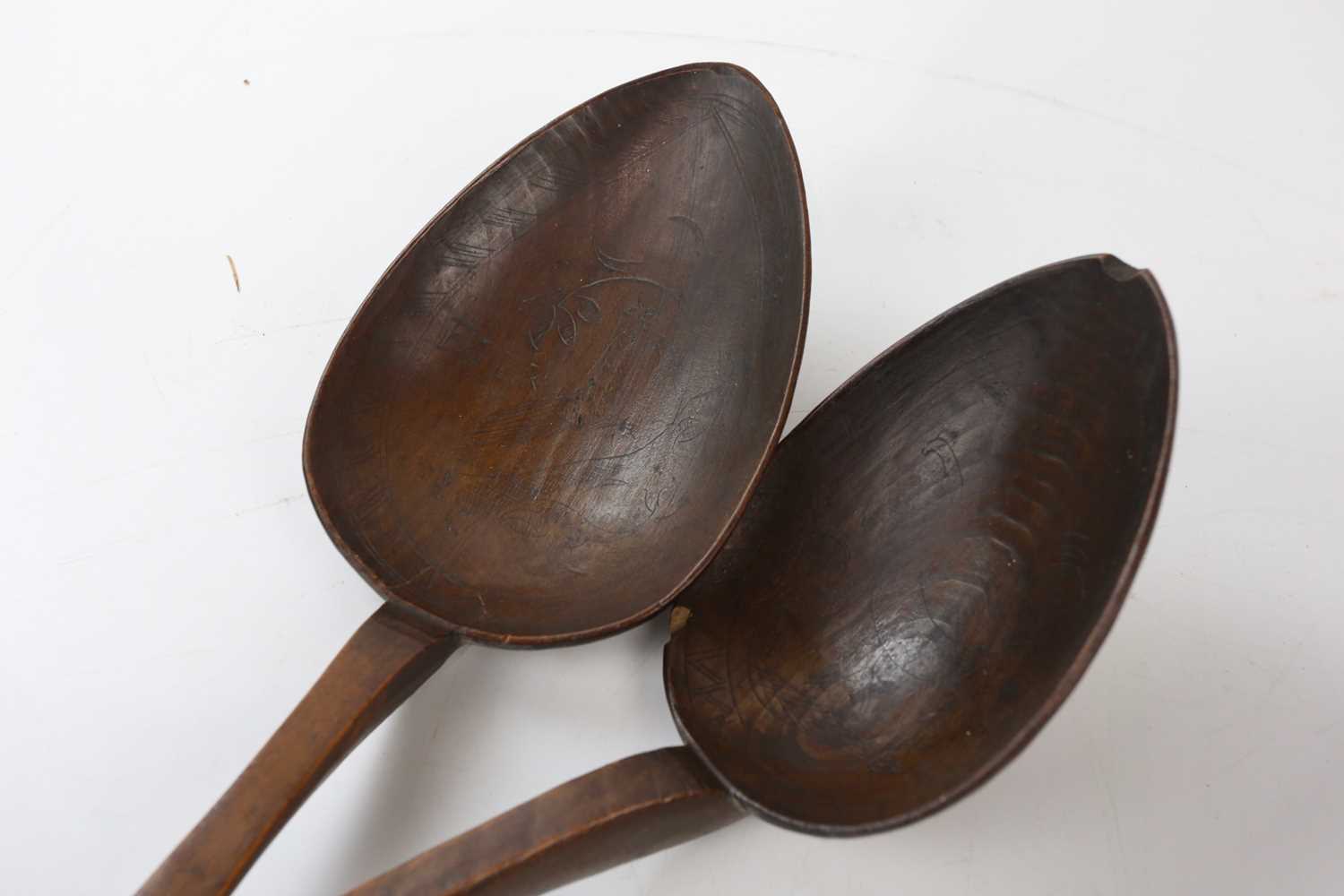 An African carved hardwood knobkerrie, length 62cm, with two carved softwood oversized spoons, - Image 2 of 4