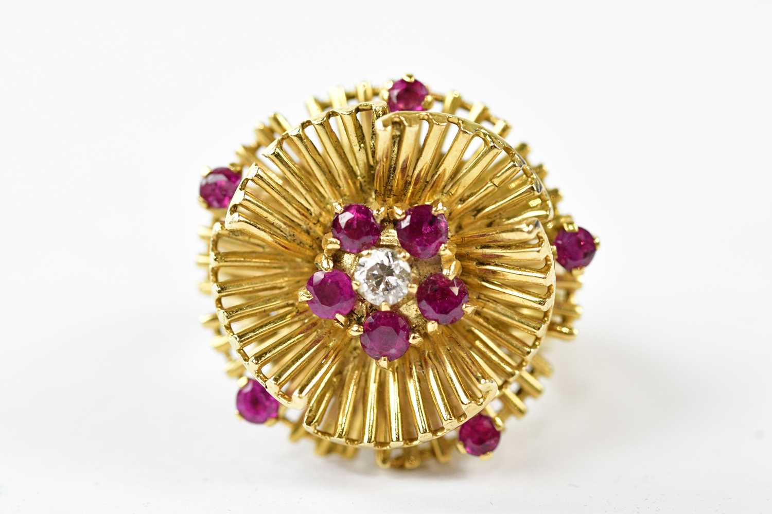 A large 18ct yellow gold floral cluster ring set with central diamond surrounded by rubies, size