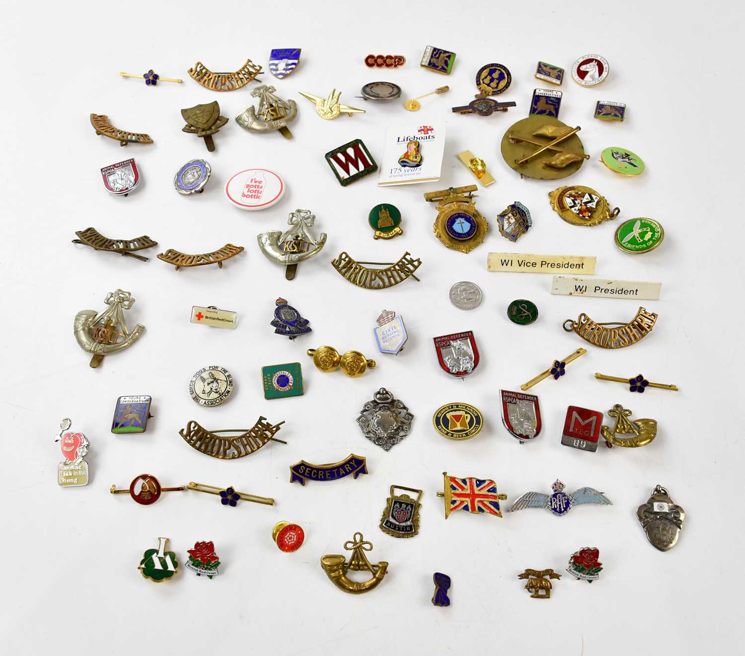 A collection of military badges to include a hallmarked silver Royal Engineers badge, with a