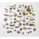 A collection of military badges to include a hallmarked silver Royal Engineers badge, with a