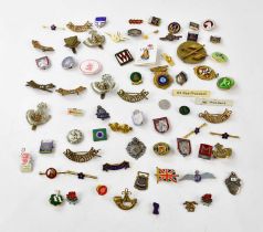 A collection of military badges to include a hallmarked silver Royal Engineers badge, with a