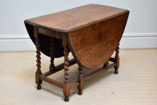 A 20th century oak gateleg table on barley twist legs, height 73cm, width 107cm, depth 56cm.