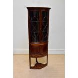 An Edwardian satinwood inlaid mahogany bowfront corner display cabinet, with two astragal glazed
