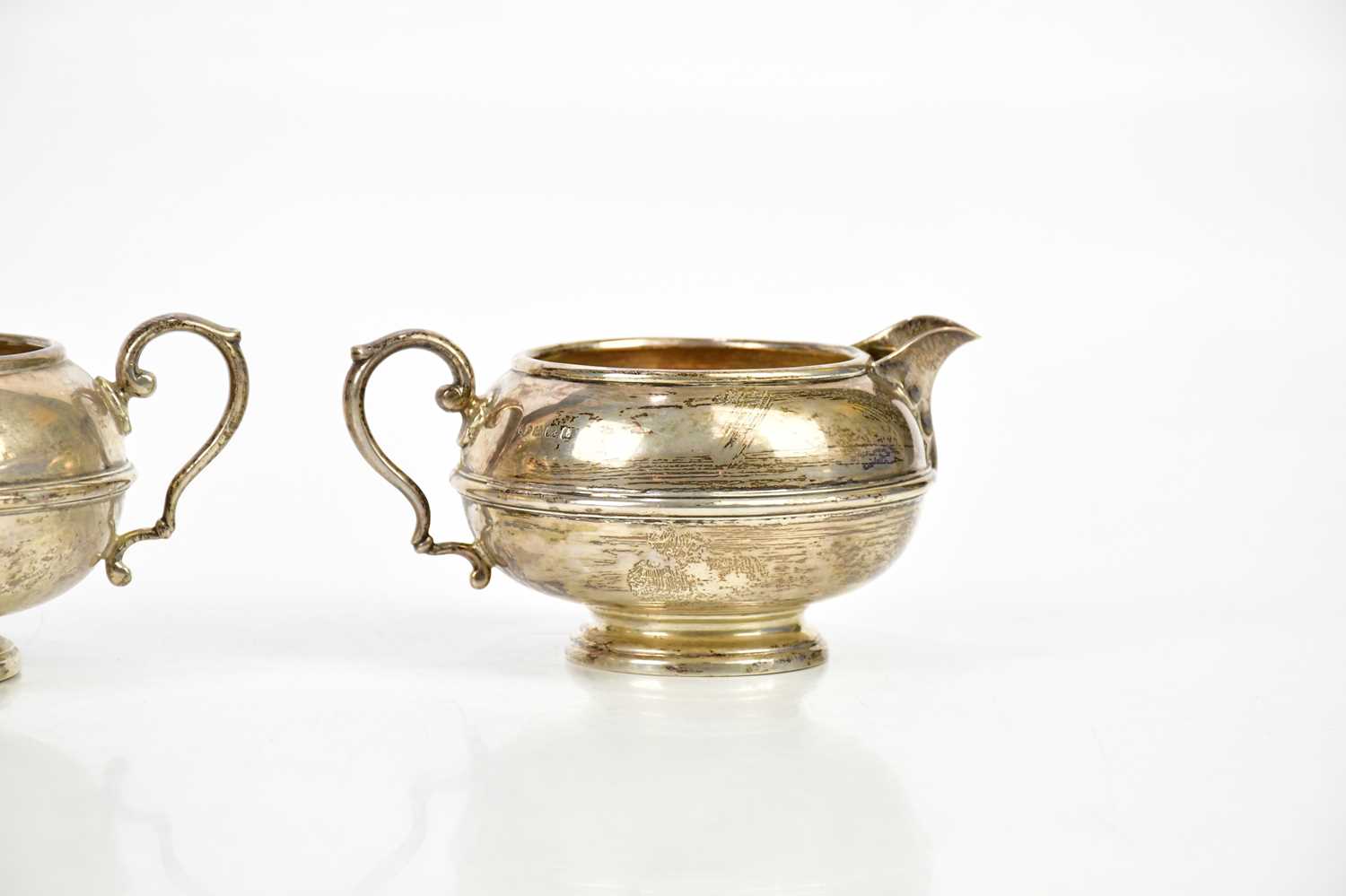 ADIE BROS LTD; a George V hallmarked silver three piece tea service of circular form, Birmingham - Bild 4 aus 4