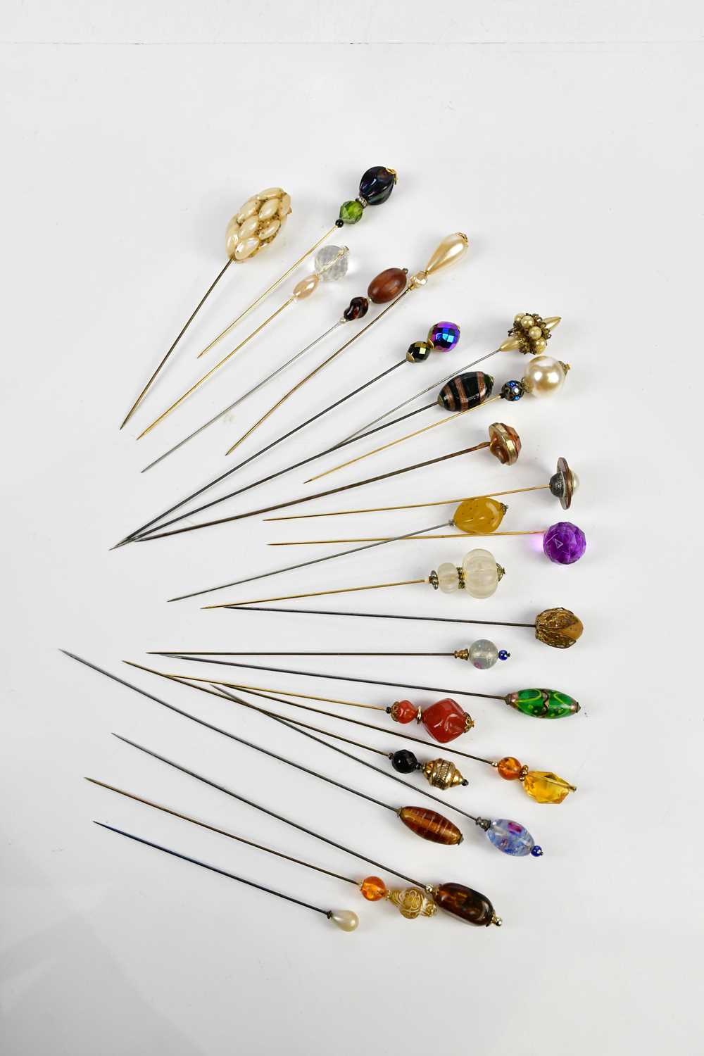 A good collection of hat pins, approximately twenty-five, including glass topped examples.