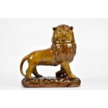 A 20th century slip glaze terracotta model of a lion with detachable head, incised mark to the