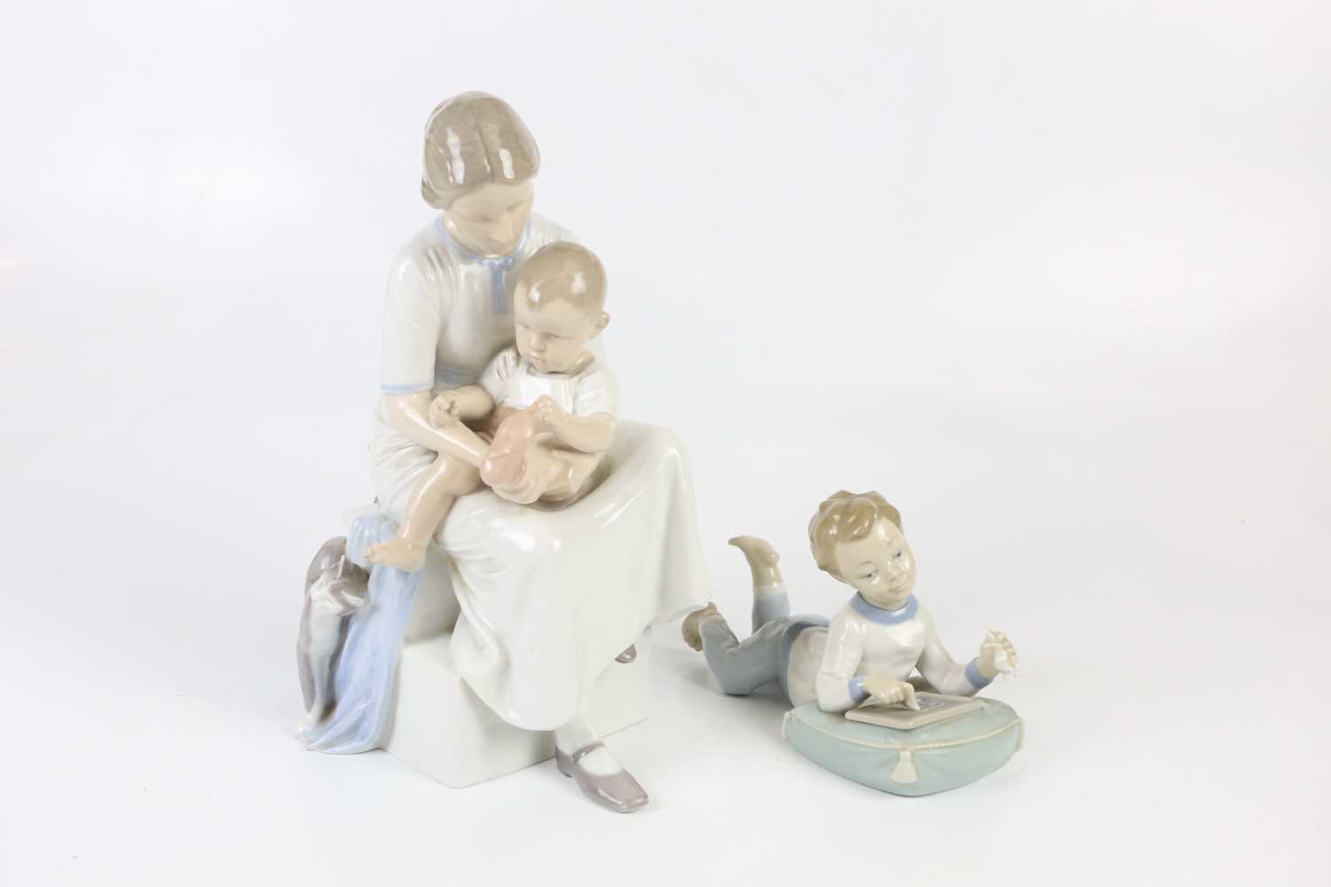 ROYAL COPENHAGEN; a figure group of mother and child, height 32cm, together with a Nao figure of