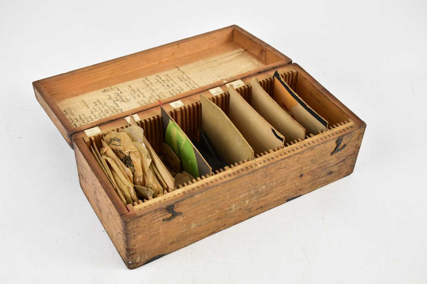 A pine box containing various violin parts, with original label to the interior.