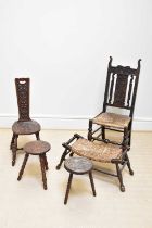 A carved oak rush seated hall chair, an oak spinning chair, two carved stools and a further rush