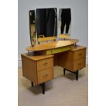 A retro mirror back dressing table with an arrangement of five drawers on block legs, width 116cm.