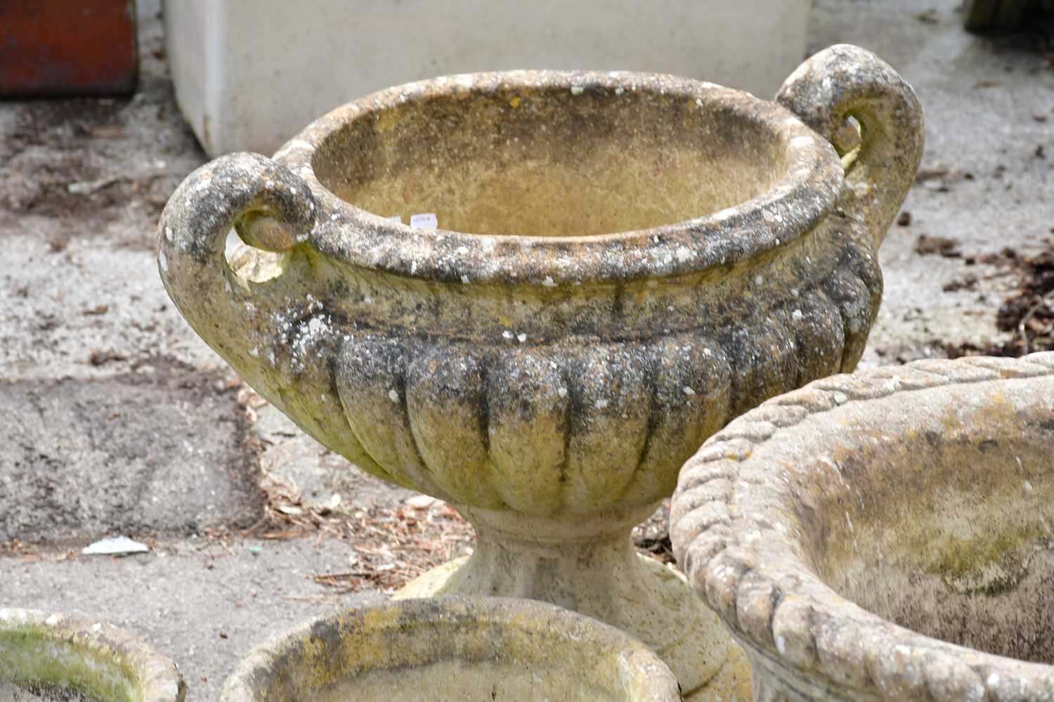 A collection of seven reconstituted garden pots, largest height 38cm, diameter 53cm. - Image 4 of 5