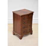 A reproduction mahogany serpentine fronted chest of four drawers, on bracket feet, height 72cm,