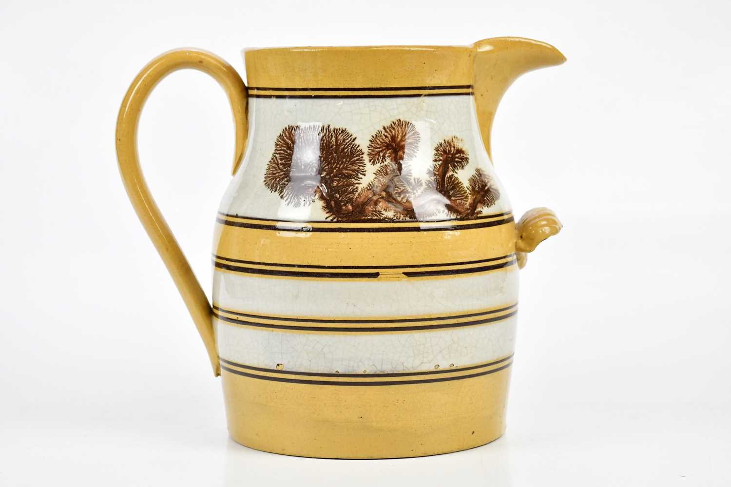 A 19th century Mocha ware jug, decorated with a pale yellow glaze, height 30cm. Condition Report: - Image 2 of 6