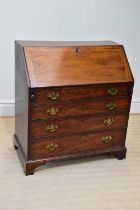 A 19th century mahogany bureau, the fall front enclosing an arrangement of drawers and pigeon