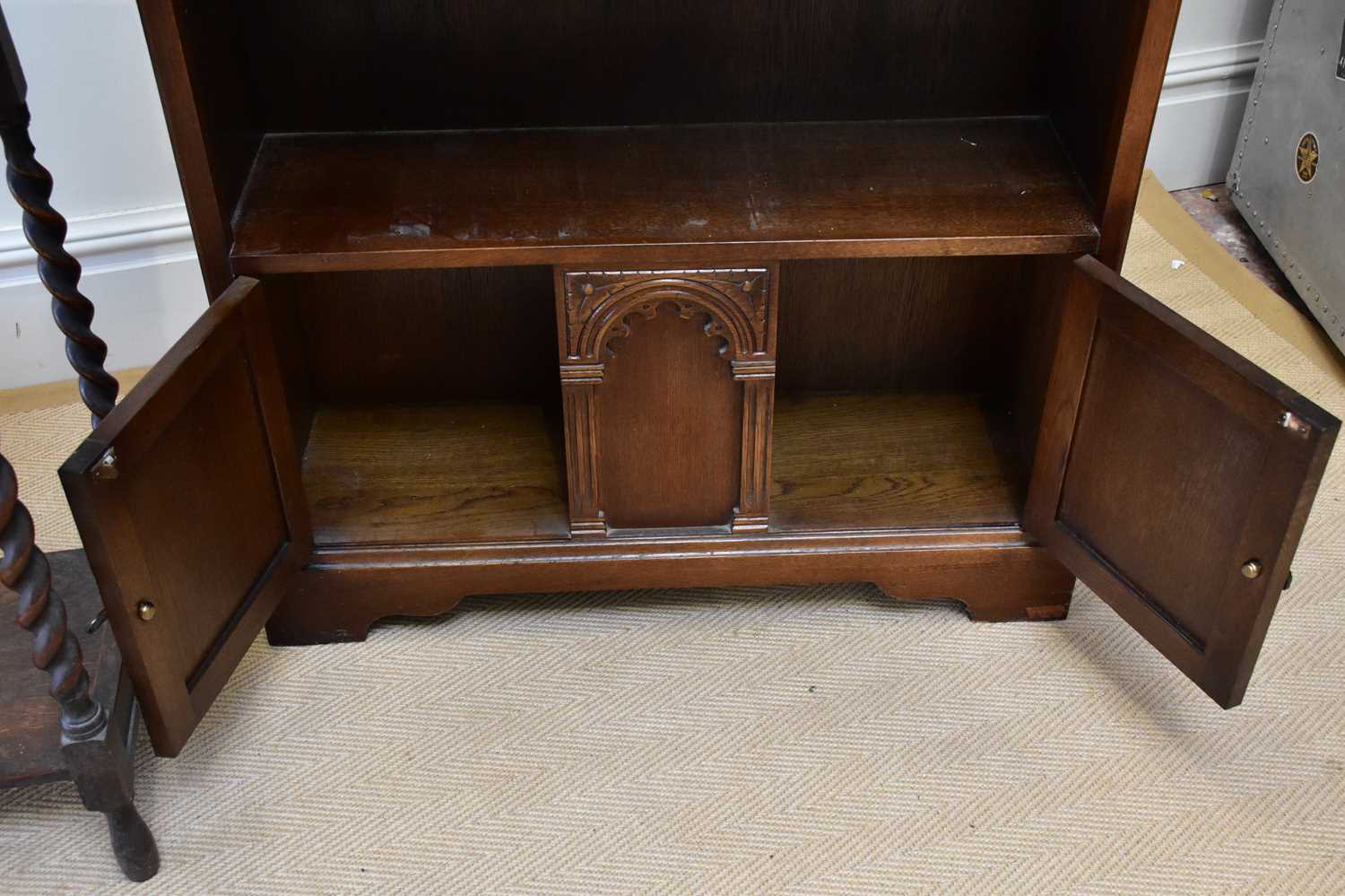 A reproduction oak freestanding bookcase with a fixed shelf above two panelled cupboard doors, width - Image 3 of 3