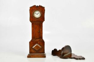 An oak miniature longcase clock, the dial set with Arabic numerals, height 36cm and an associated