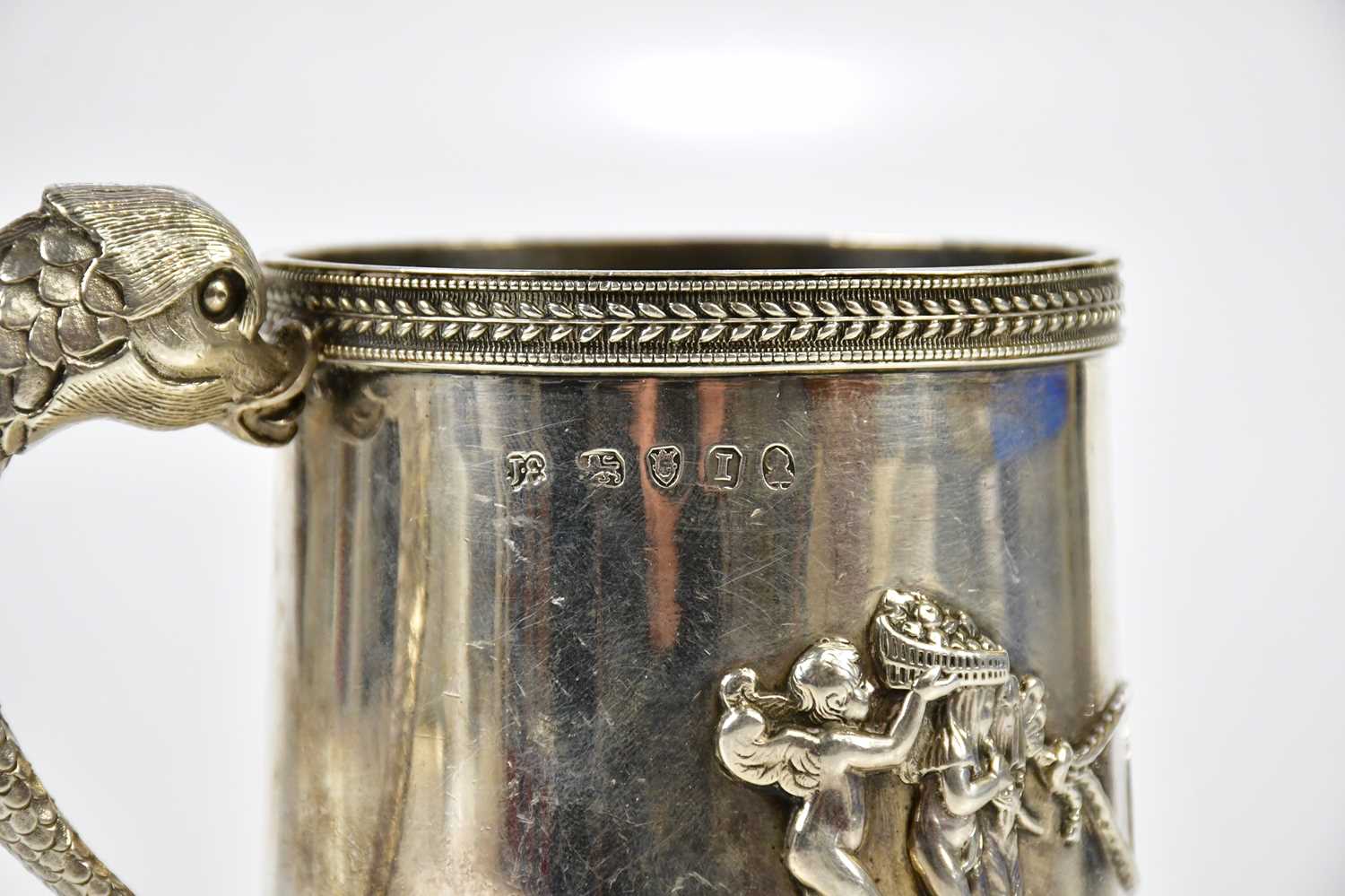 JOHN EMES; a George III hallmarked silver mug, with dolphin handle and cast borders within which - Image 5 of 6