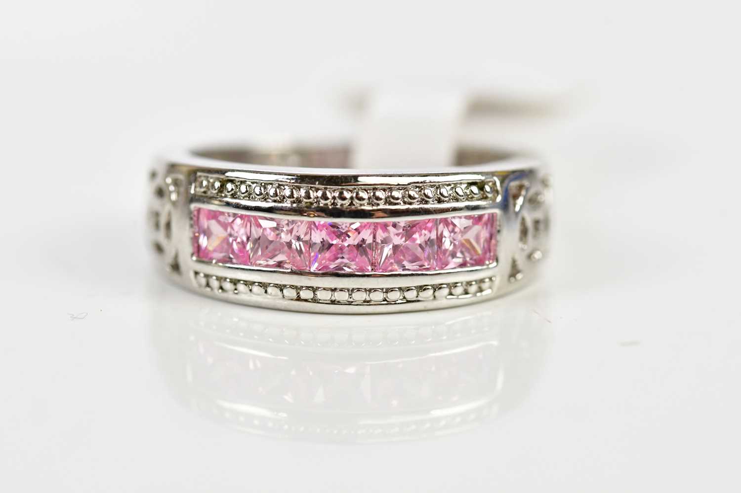 A silver and pink sapphire set half eternity ring, size L, weight 3.7g.