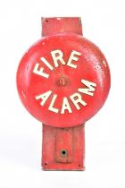 A vintage cast iron fire alarm bell, on wooden backplate, diameter of bell 30cm (no internal