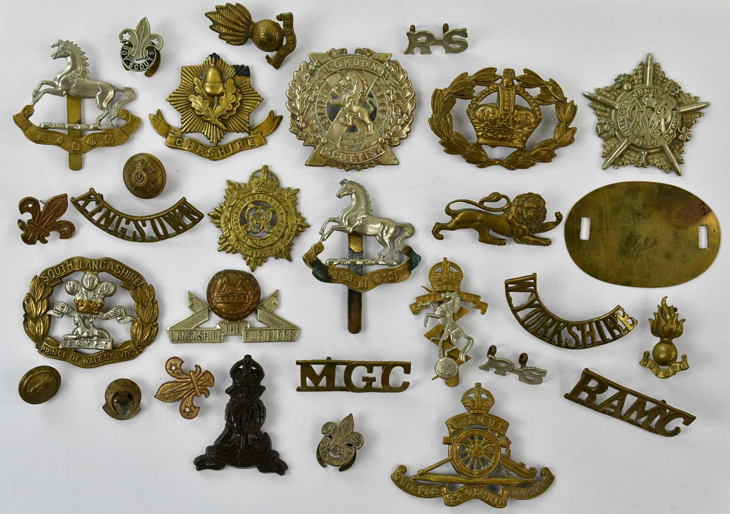 A small collection of assorted cap badges including the Cheshire Regiment, Royal Artillery, London