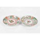 Two 19th century Chinese Famille Verte Wucai plates, each decorated with floral sprays within