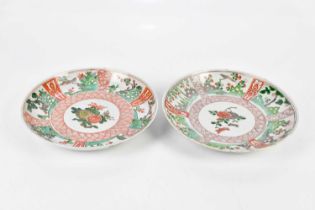 Two 19th century Chinese Famille Verte Wucai plates, each decorated with floral sprays within