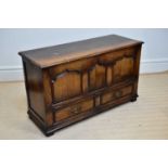 TITCHMARSH & GOODWIN; a reproduction oak coffer with panelled fall front and two base drawers, width