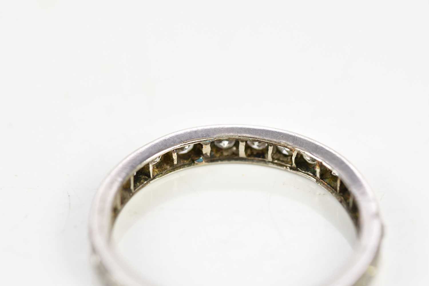 A white metal diamond set eternity ring, size O, approx 3g. - Image 3 of 3
