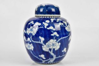 An early 20th century Chinese blue and white porcelain ginger jar and cover decorated with prunus