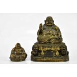 A bronzed figure of a seated Buddha and Dogs of Fo, height 22cm, together with a further smaller