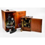 A vintage mahogany cased microscope, together with slides, also a further mahogany cased brass