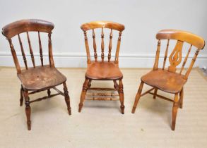 Three 19th century kitchen Windsor chairs including an example with double stretcher.