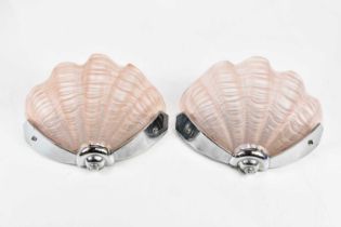 A pair of Art Deco style chrome and moulded pink tinted glass wall lights modelled as shells,