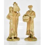 ROYAL WORCESTER; a pair of blush ivory figures, Arab male and female water carriers, numbered