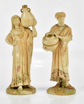 ROYAL WORCESTER; a pair of blush ivory figures, Arab male and female water carriers, numbered