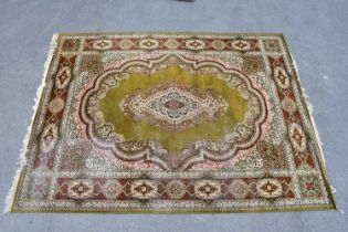 A large green ground Keshan carpet, 360cm x 275cm.