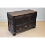 A late 17th century carved oak mule chest with panelled front above two base drawers, dated 1696,