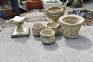 A collection of seven reconstituted garden pots, largest height 38cm, diameter 53cm.