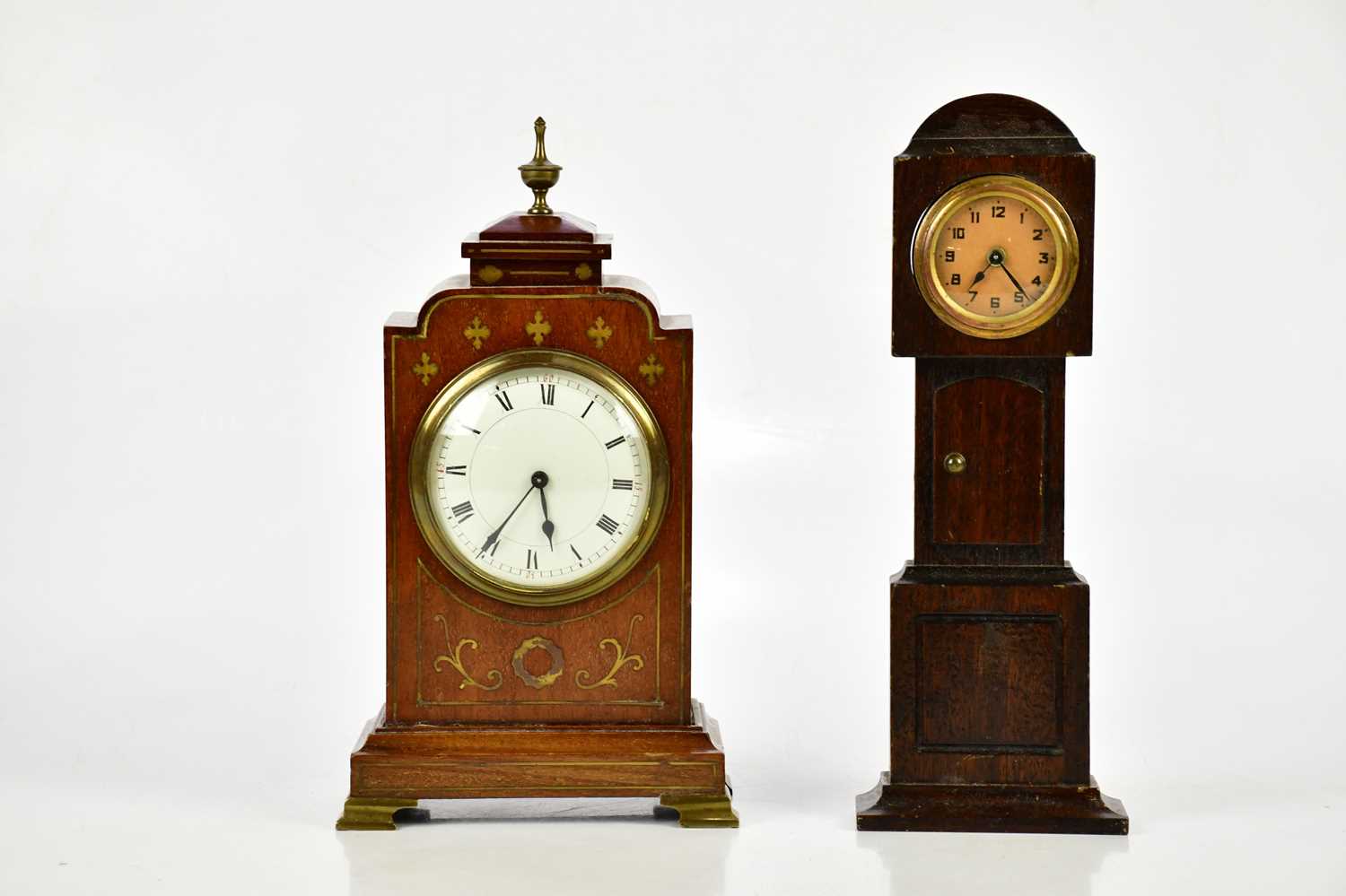 A late 19th century brass inlaid mahogany mantel clock, with brass urn finial above the enamel