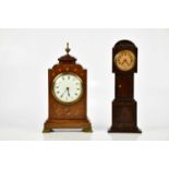 A late 19th century brass inlaid mahogany mantel clock, with brass urn finial above the enamel