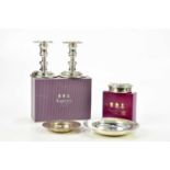 ASPREY; a pair of Elizabeth II hallmarked silver candlesticks with detachable drip trays, double