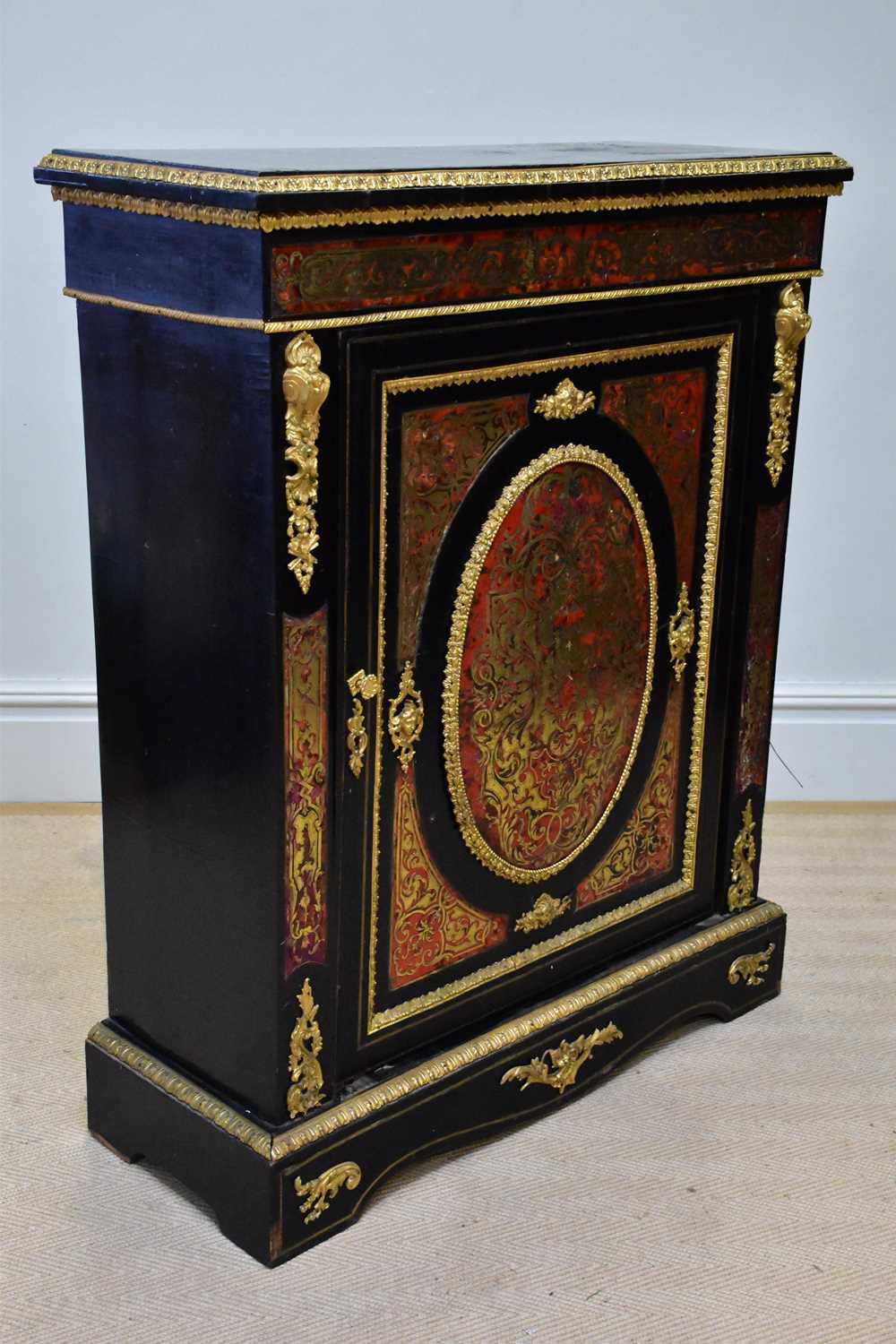 A 19th century ebonised brass bound Boulle work pier cabinet, with single panelled door on plinth