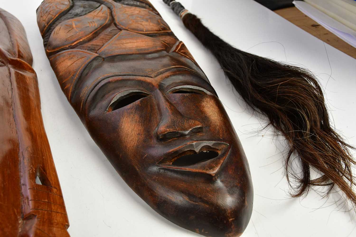 A collection of six decorative African masks, largest 63cm, together with animal hair fly swatter. - Image 4 of 5