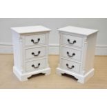 A pair of modern cream three drawer bedside chests, with fluted corner pilasters, on bracket feet,