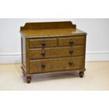 A Victorian scrumbled pine chest of drawers with raised back above two short over two long drawers